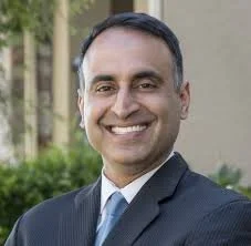Portrait of a Ash Kalra in a suit outdoors
