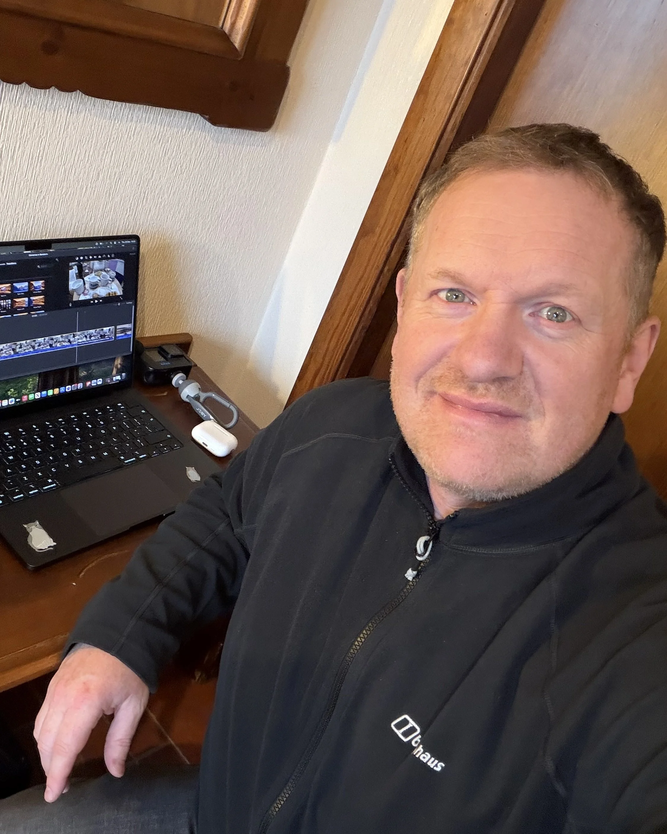 Steve sitting at desk with laptop editing