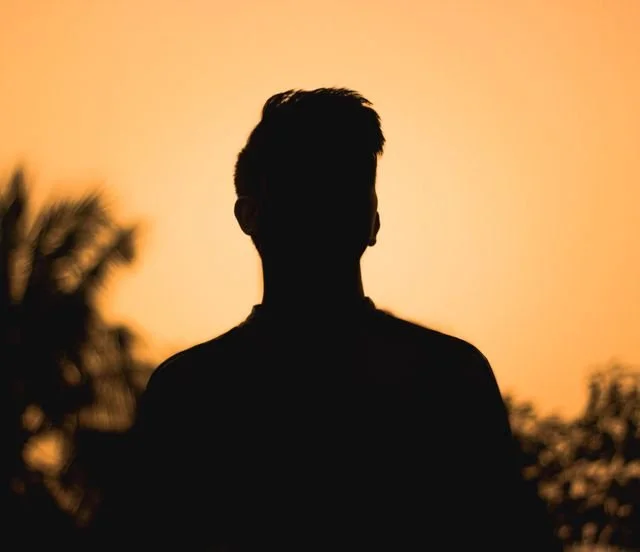 A person in a orange sillouette background