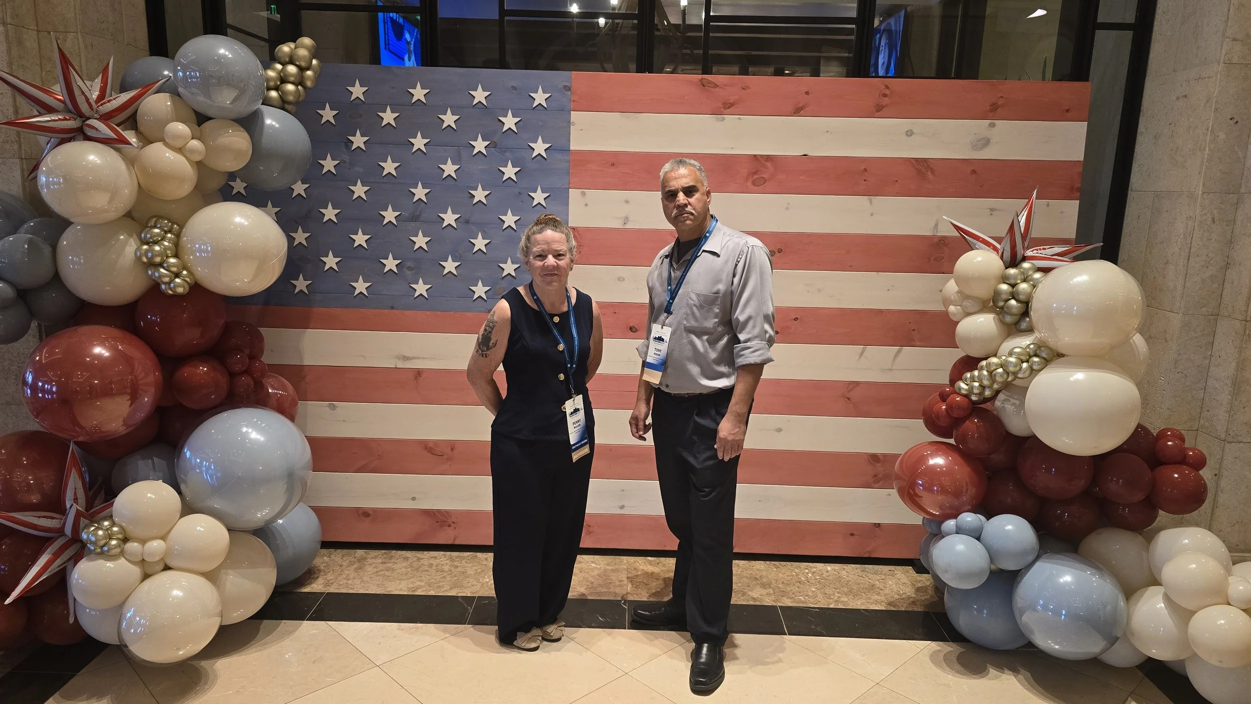 Penny and Tony, owners of veteran-owned Peninsula Care Shuttle, at Non‑Emergency Medical Transportation Accreditation Commission (NEMTAC) Conference 2026