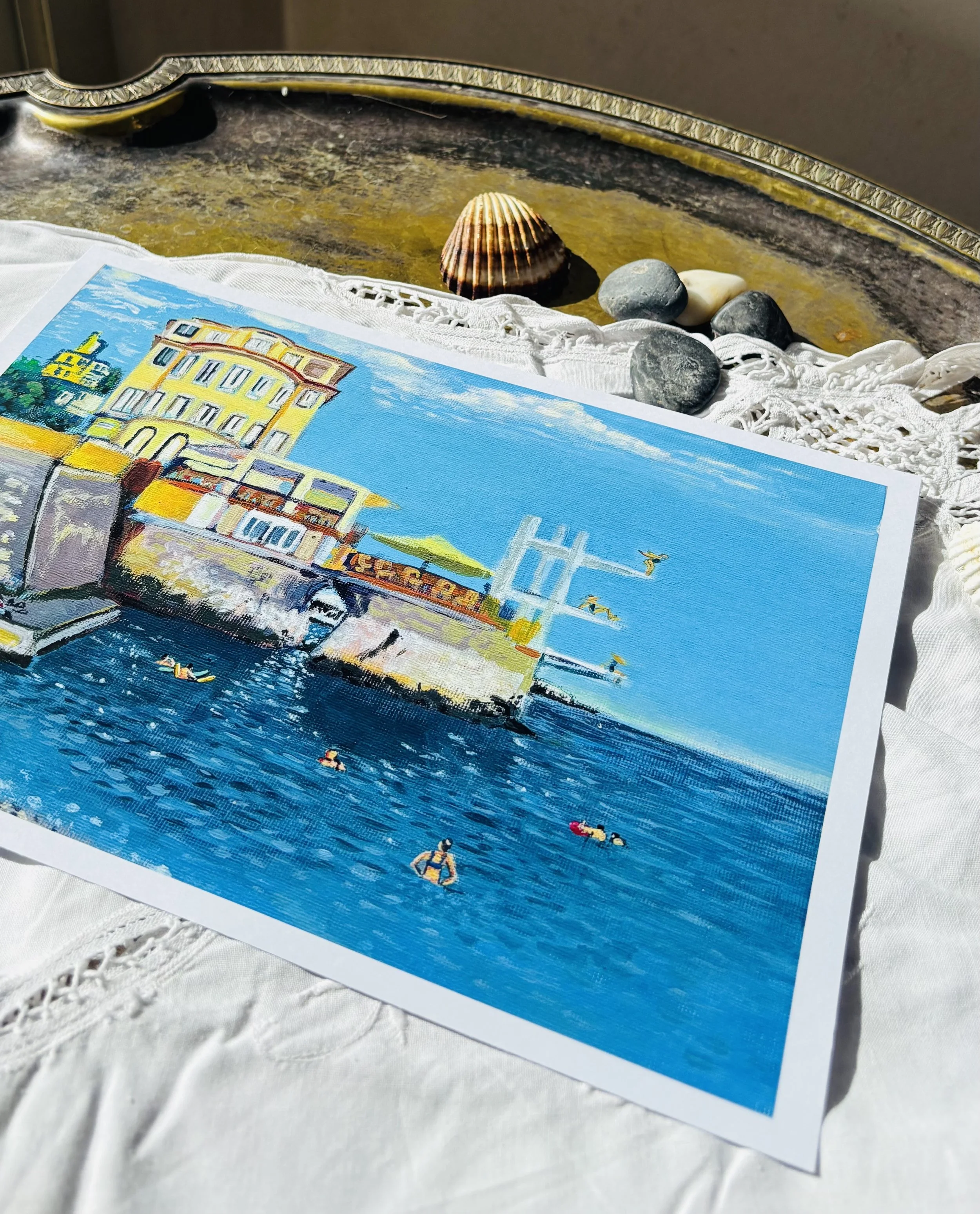Colorful painting of a beach scene with a building and people swimming