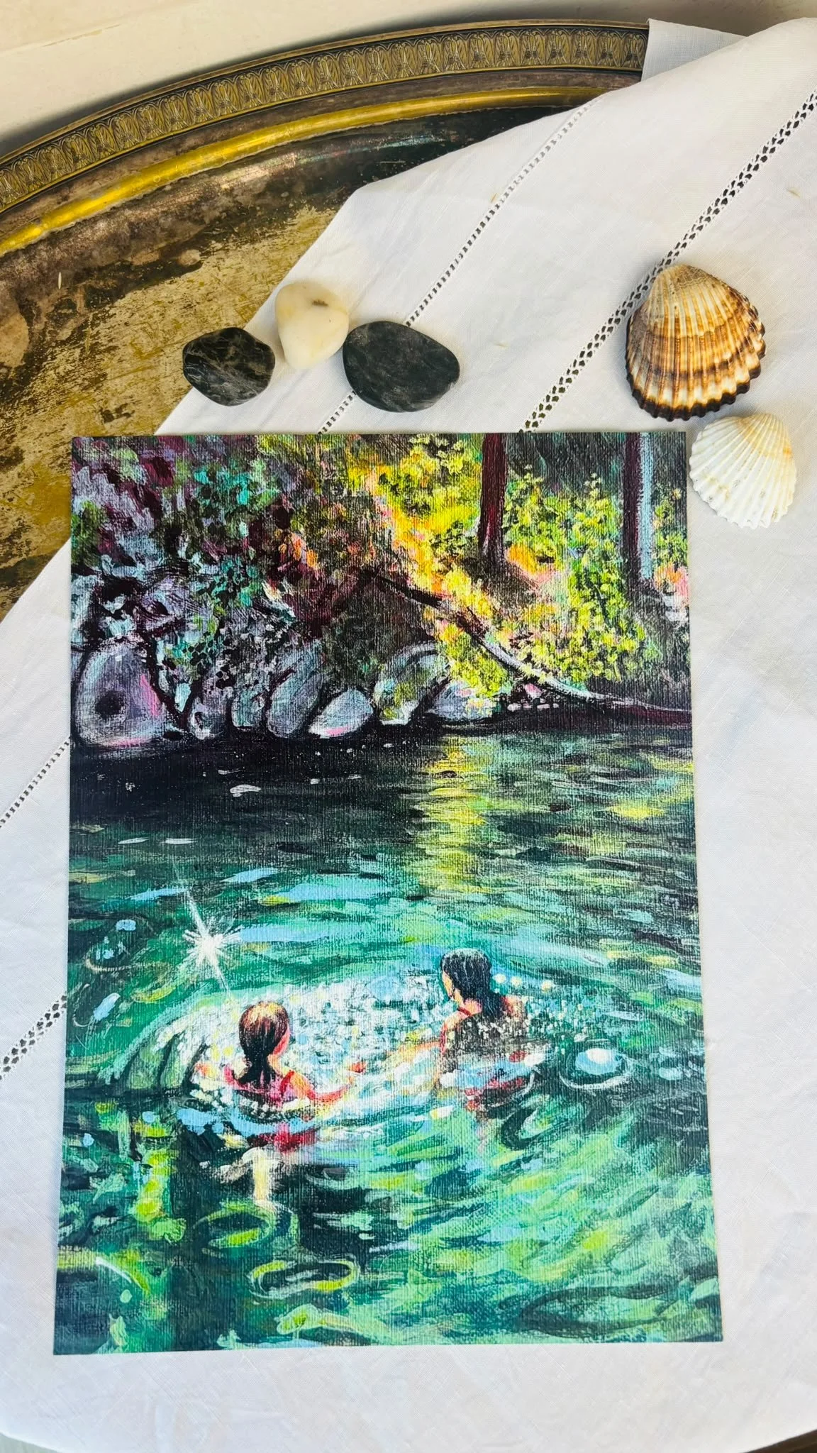 A colorful painting of two children swimming in a body of water with a rocky, tree-covered background.