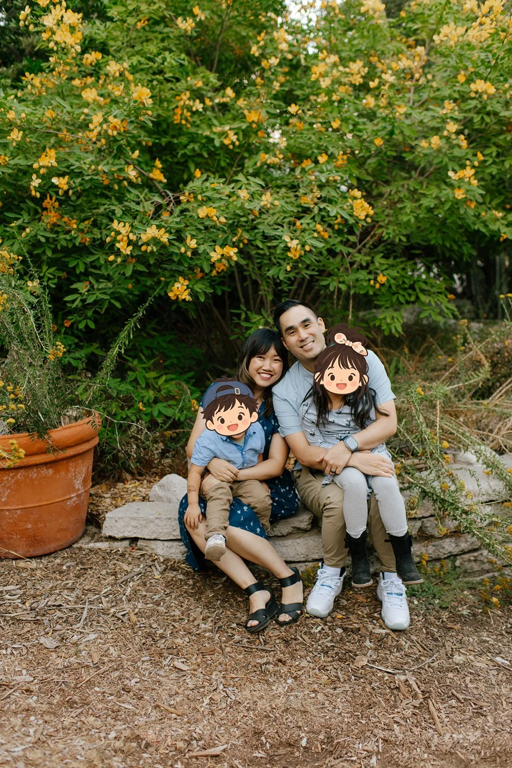 family photo of the financial planner Cathy, her husband and two children whose face are covered by emoji to protect their privacy.