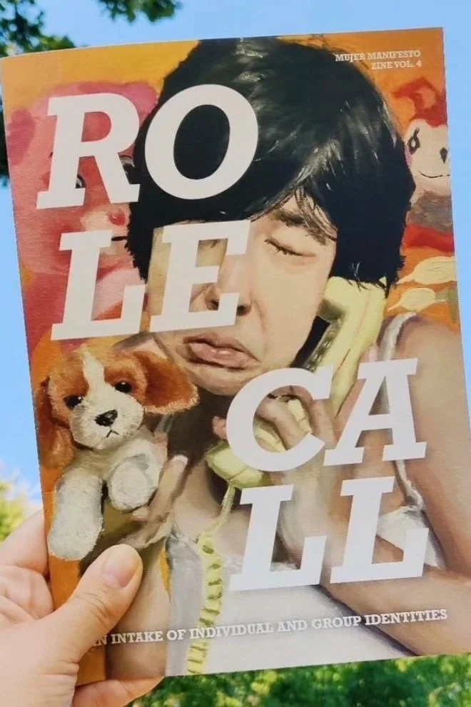 Close-up of a magazine cover titled 'ROLE CALL.' It features a young boy making a facial expression while holding a vintage yellow telephone to his ear, with a small brown and white plush puppy in his other hand. The background has colorful elements, including a panda illustration, and the magazine appears to focus on identity topics.