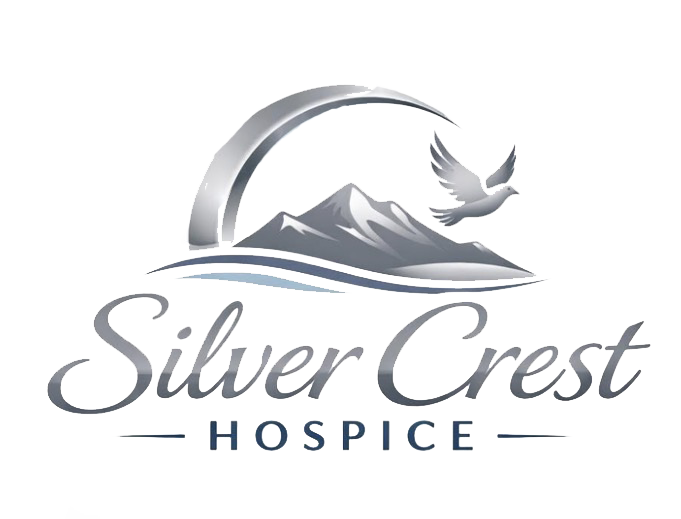 Silver arch with mountains, a dove, and the text 'Silver Crest HOSPICE' underneath.