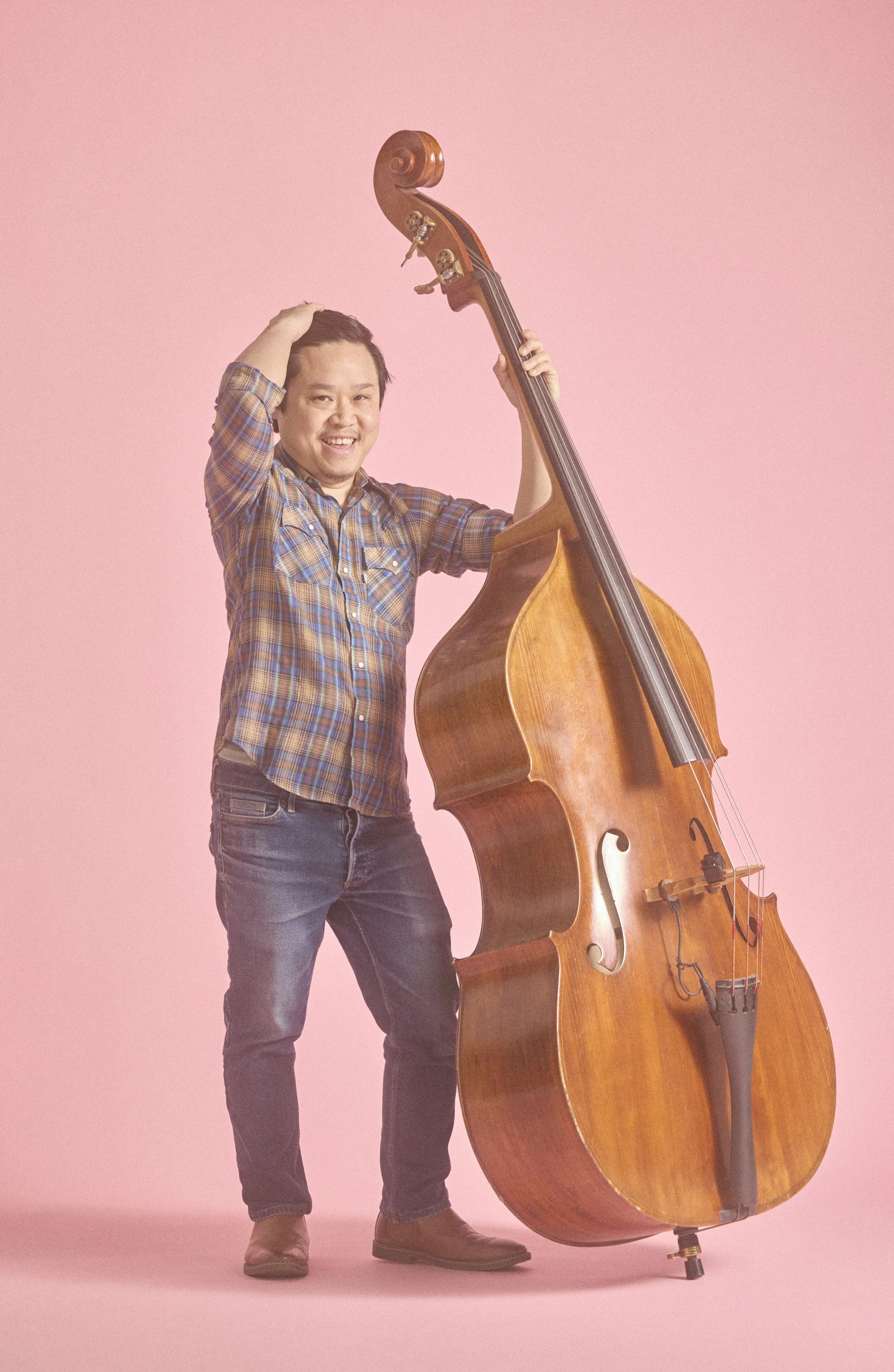The Talking Hearts bandmate Dan Bui holding an upright bass