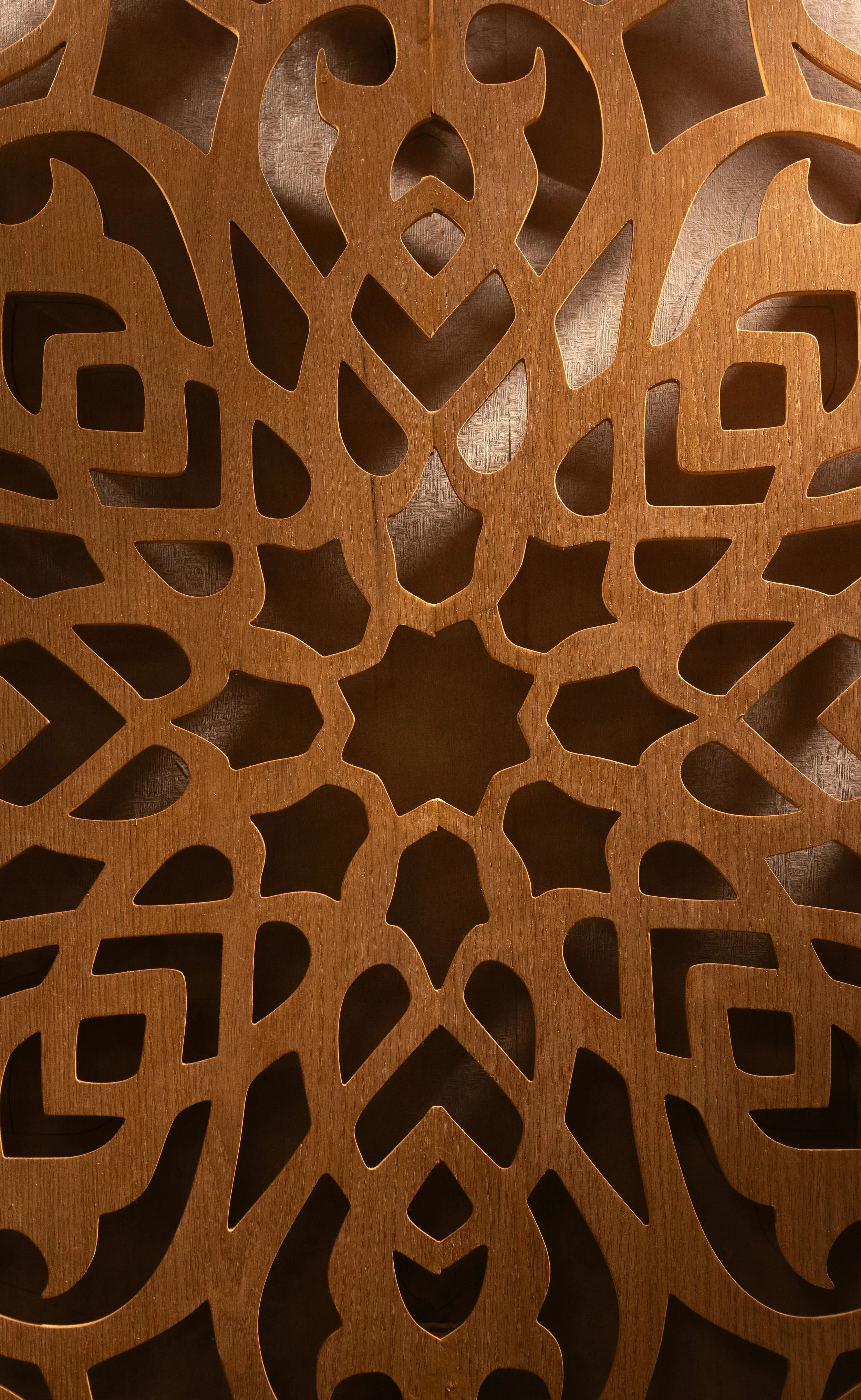 Wooden decorative panel with intricate cut-out patterns.