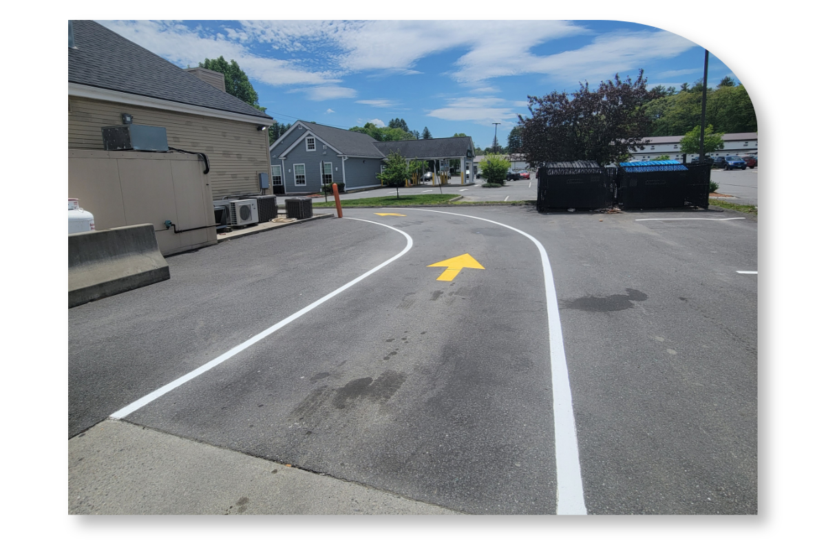Fresh paint lines with arrow forming a driving lane at a business