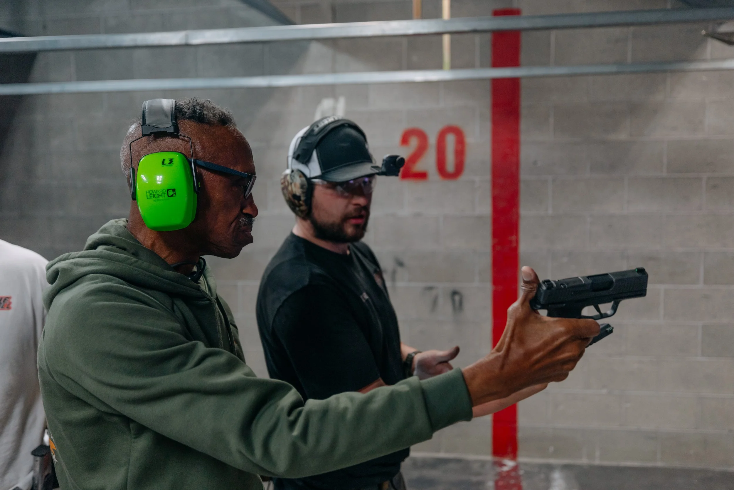 A person is getting some tips from the range officer at Tactical Penguin.