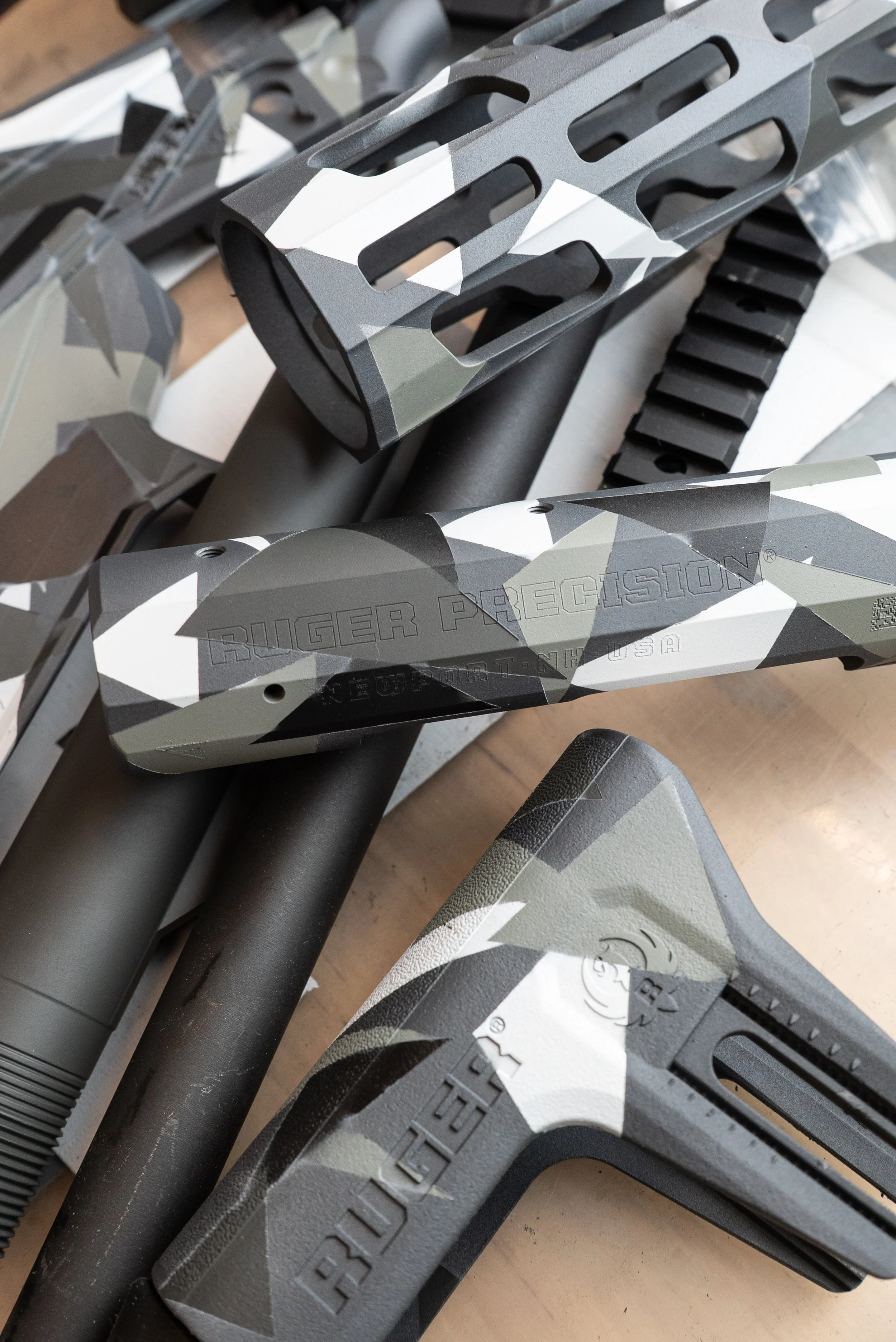 A pile a camo cerakote products made by Tactical Penguin.