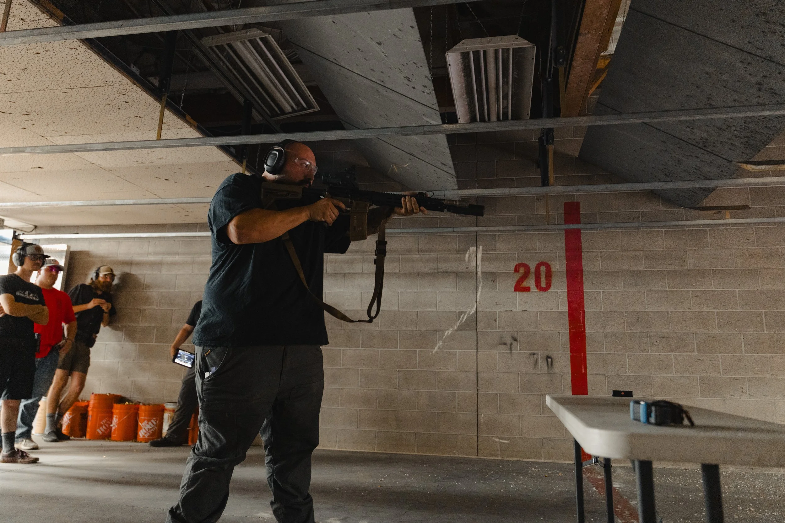 A person with a pew during Accushoot Night at Tactical Penguin.