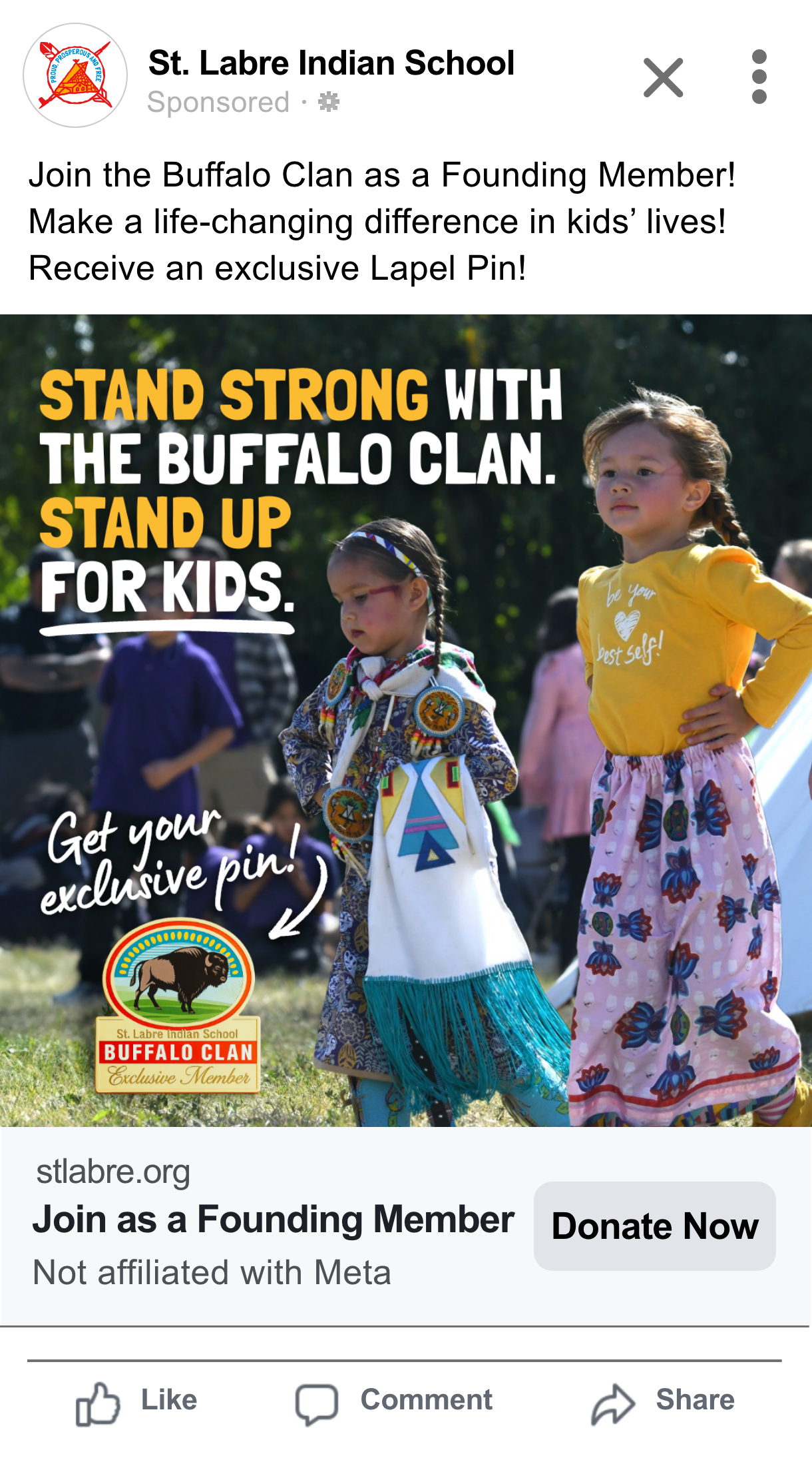 Two young girls dressed in traditional Native American attire, standing outdoors at a cultural event, with onlookers in the background. The image promotes joining the Buffalo Clan at St. Labre Indian School.