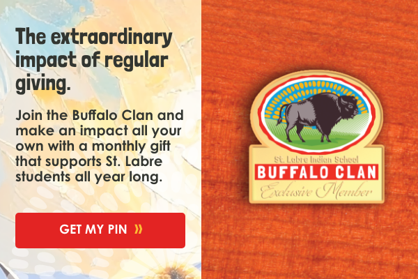 Advertisement promoting giving to the Buffalo Clan to support St. Labre students, featuring a red button labeled 'Get My Pin' and a buffalo clan logo with a buffalo image.