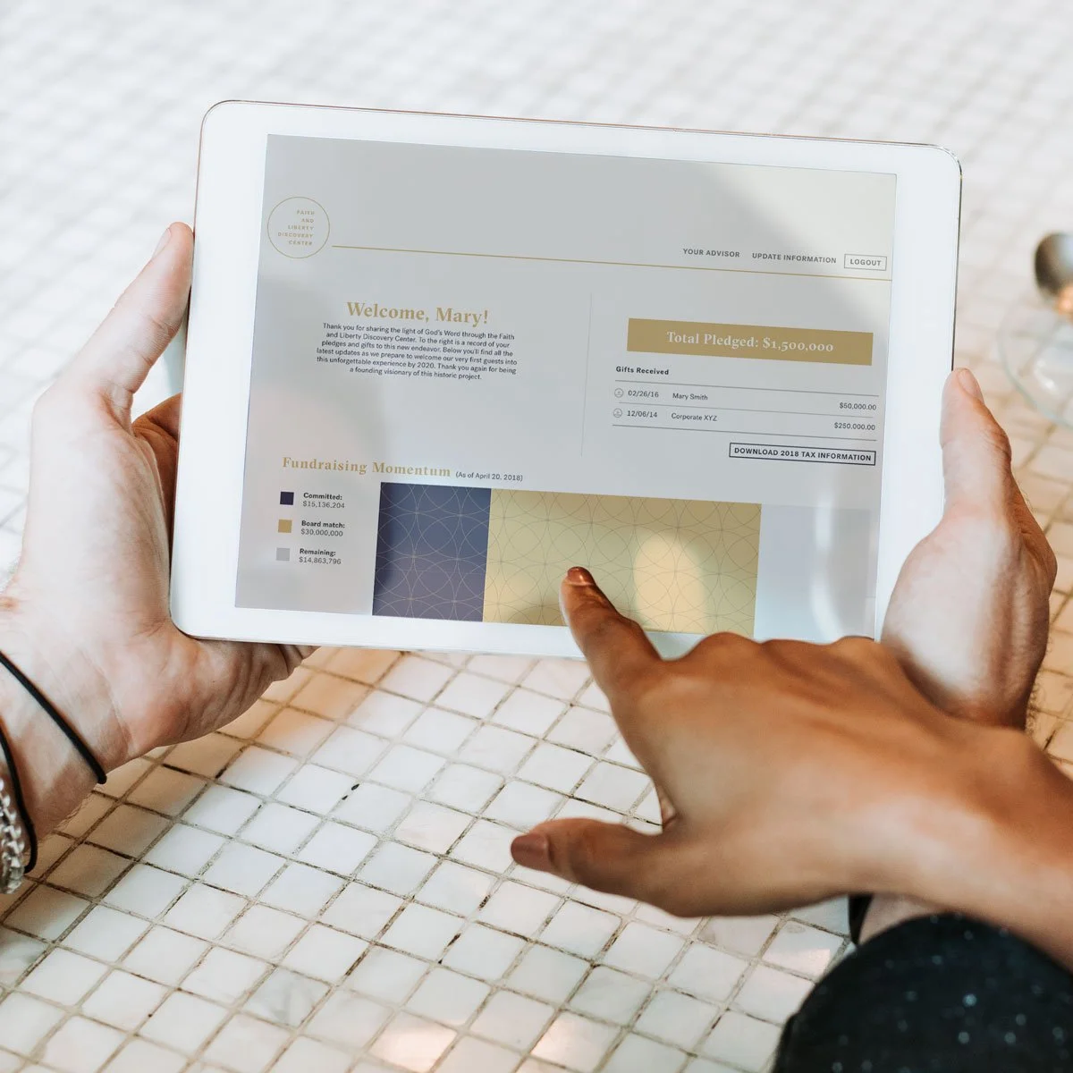 Person holding a white tablet showing a fundraising dashboard with donation details and a progress chart.