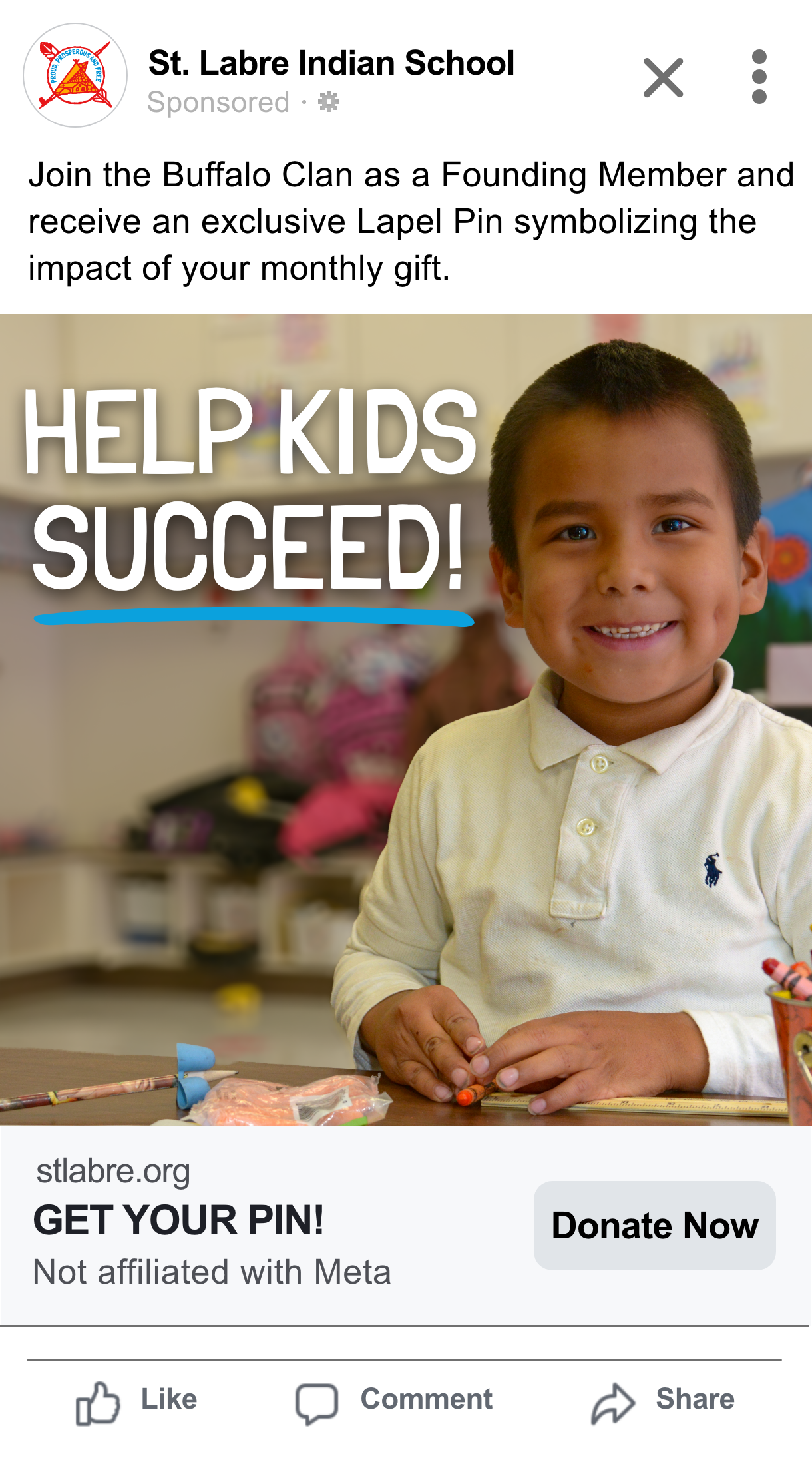 Young boy smiling in a classroom, with school supplies and classroom decorations around him.