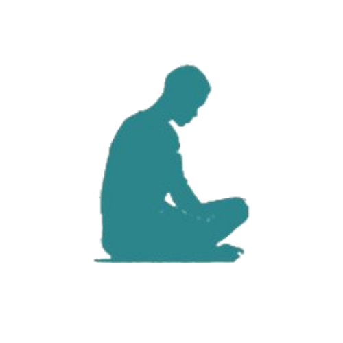Silhouette of a person sitting and reading a book.