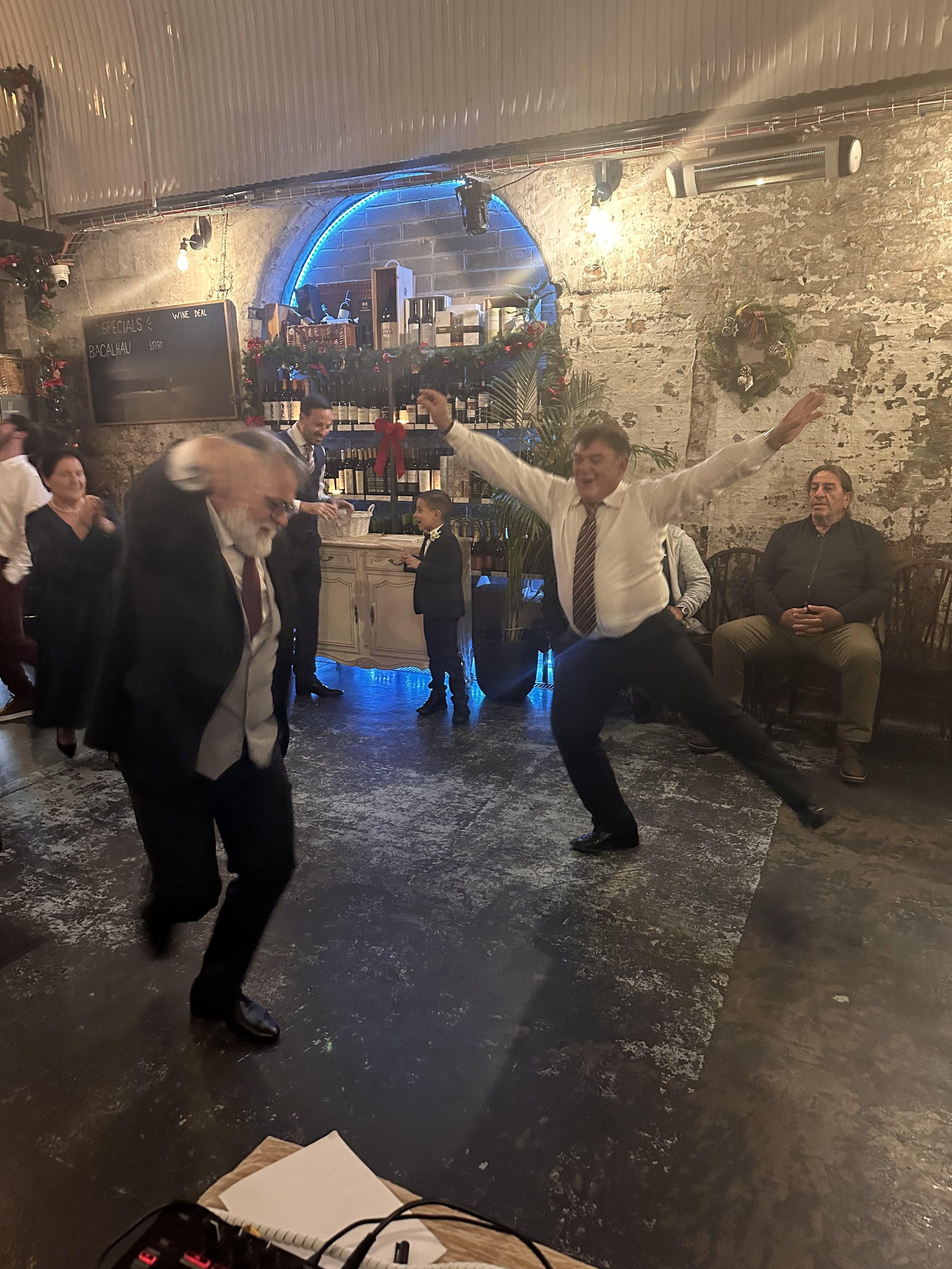 Guests dancing at a Greek celebration with Lucky Evi DJing in Londo