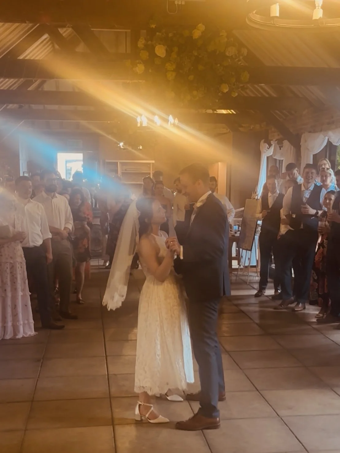 Bride and groom sharing first dance at London wedding reception with DJ lighting