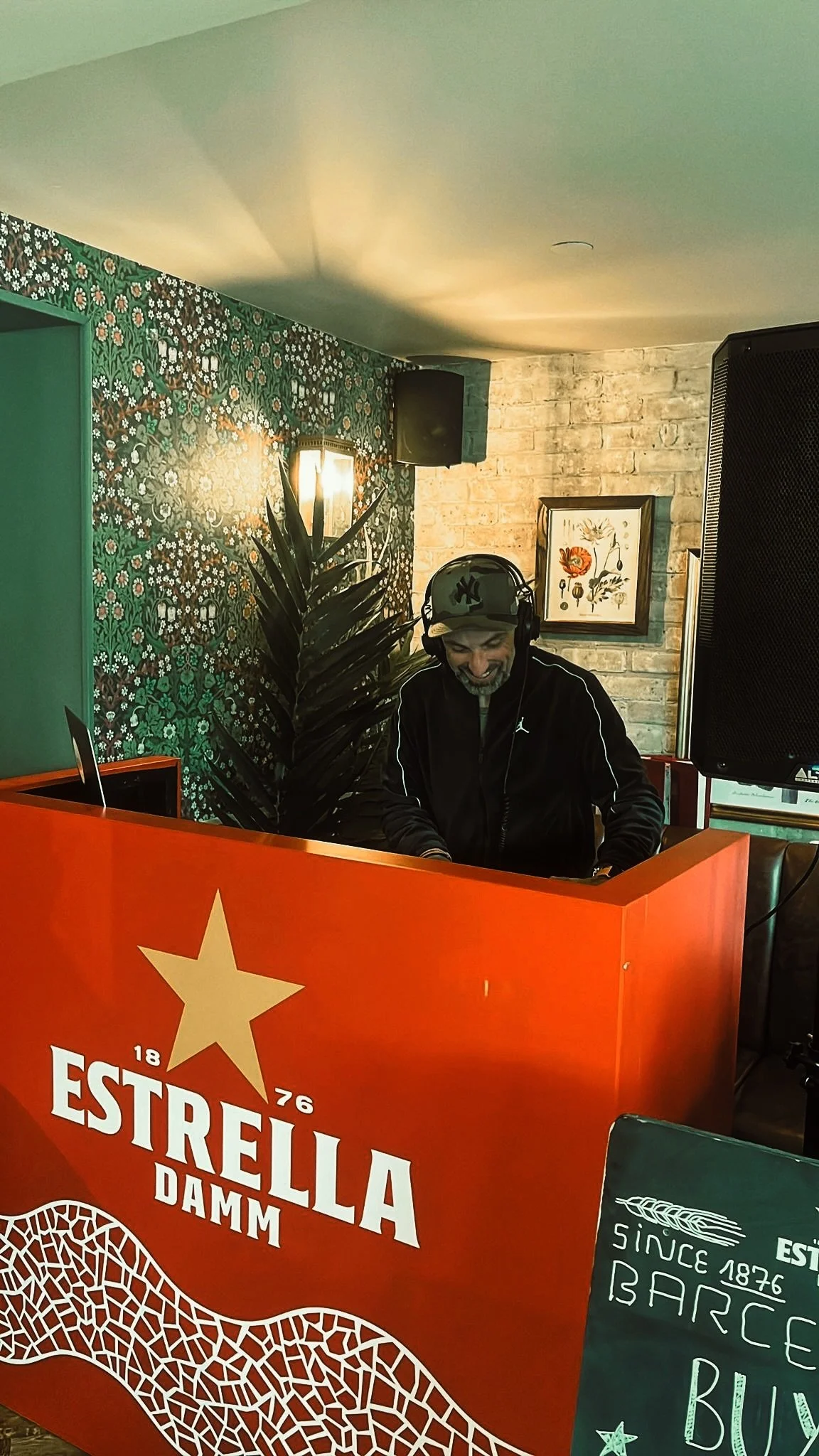 DJ Lucky Evi performing at corporate event with brand branding