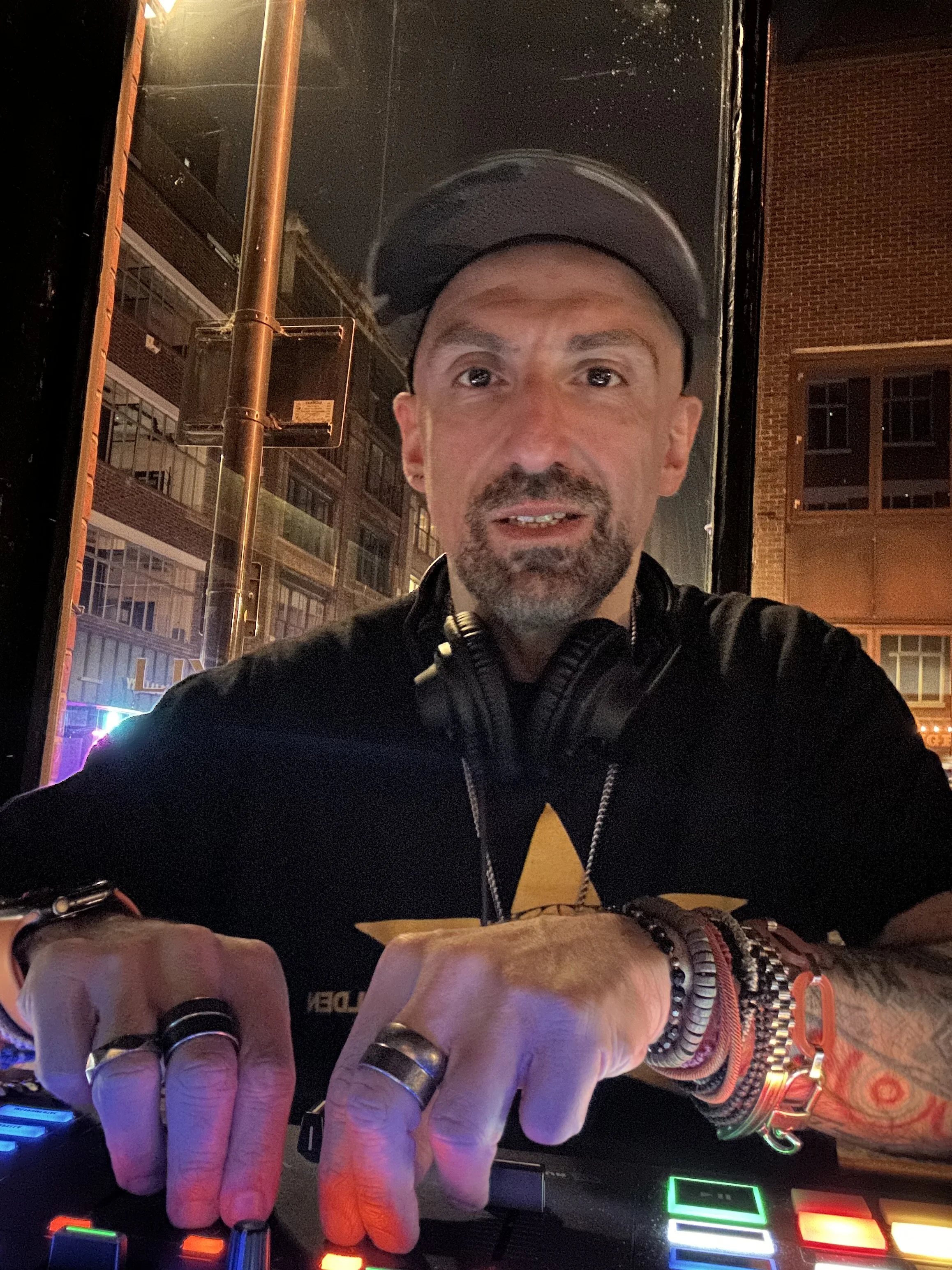 Lucky Evi mixing at DJ decks in London at night