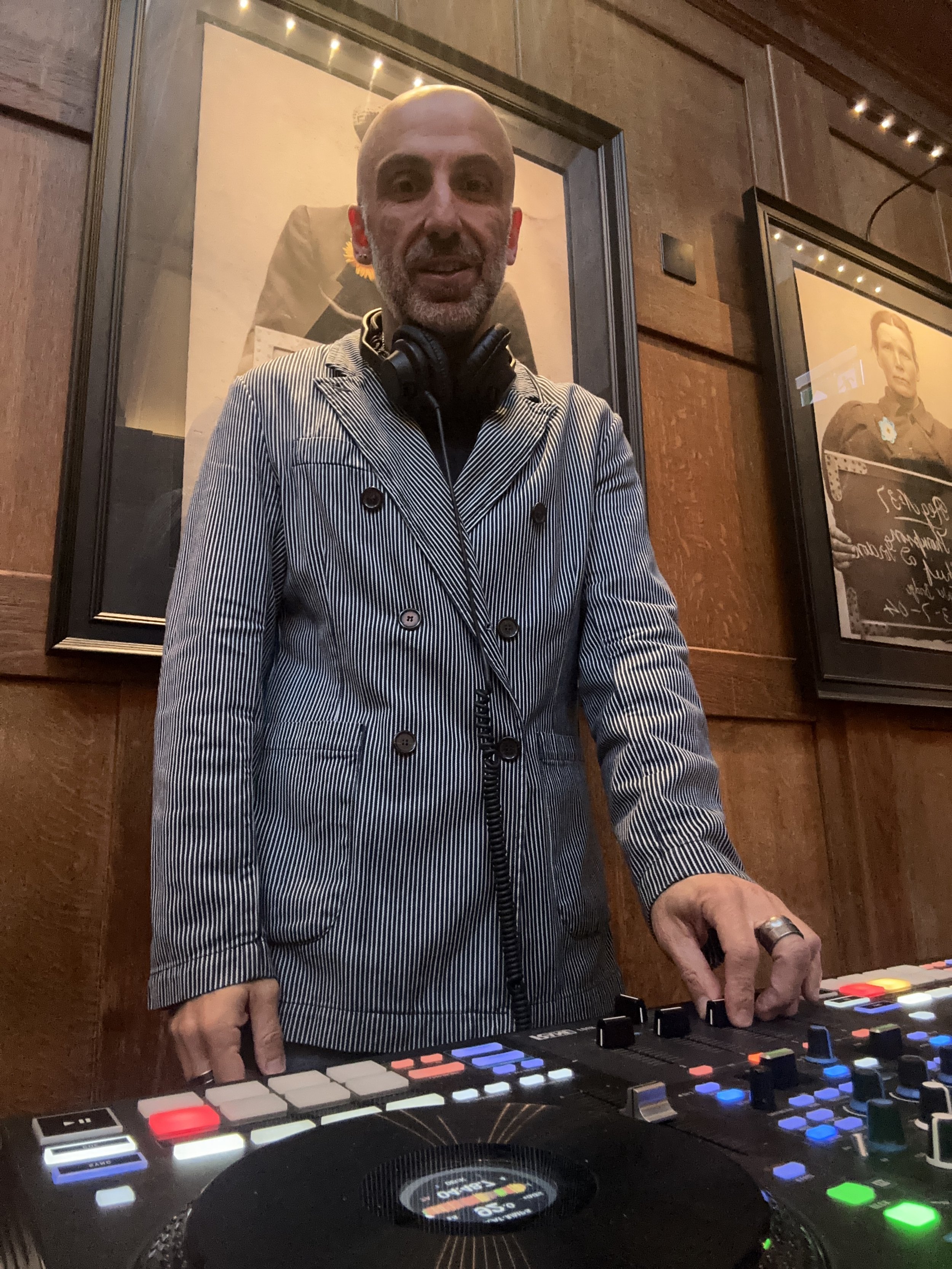 Lucky Evi, London DJ, performing at a private event in a wood-panelled venue in London.