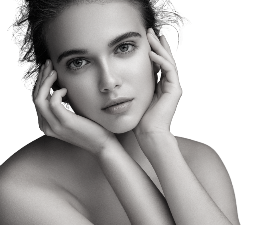 Black and white portrait of a young woman with hands near her face looking directly at the camera.