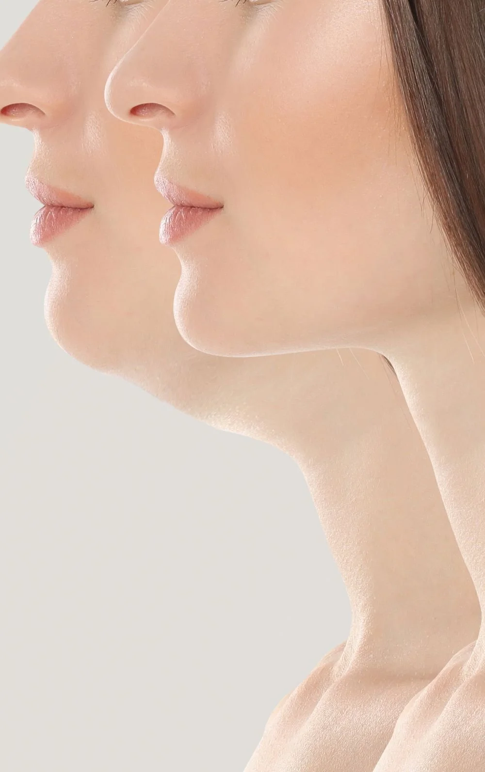 Side profile of a woman with clear skin, softly smiling, with long dark hair, set against a light background.
