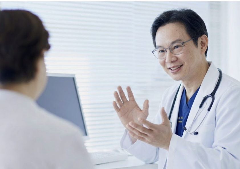 Doctor speaking with a patient in a medical office.