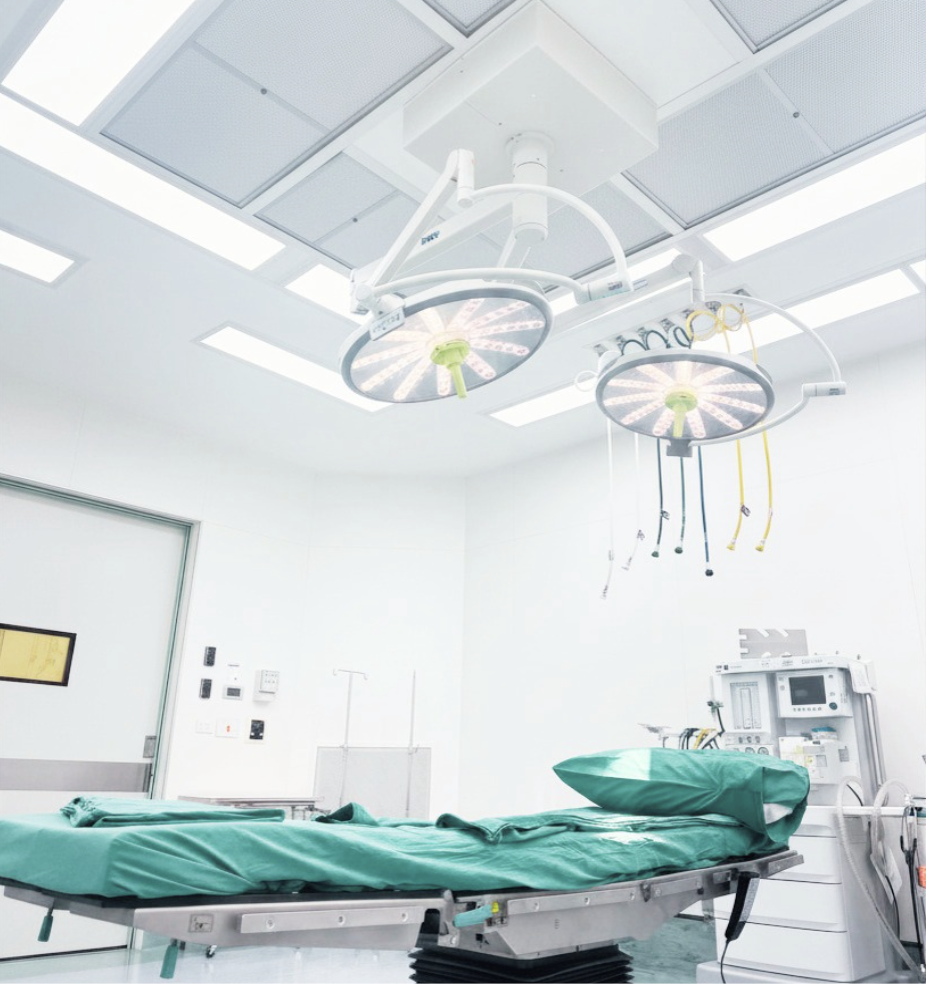 Empty operating room with hospital bed and surgical lights