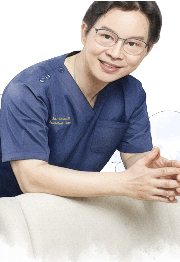 A smiling woman in medical scrubs with glasses, sitting at a table with hands folded.