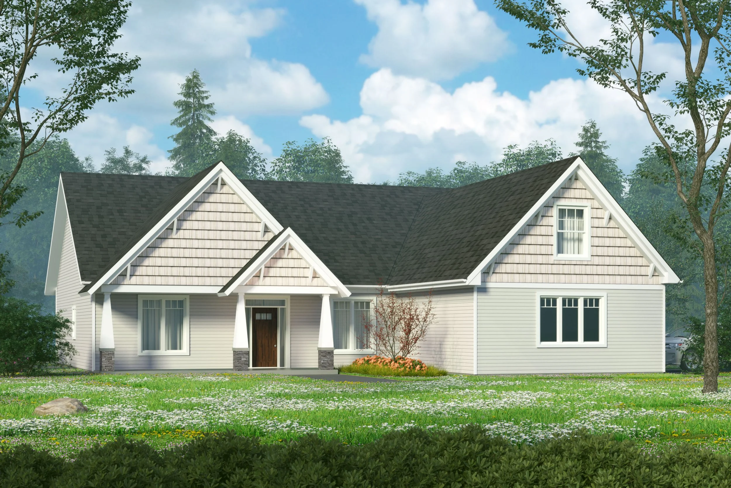 A white house with a dark gray shingle roof, surrounded by trees and a grassy yard with small flowers.