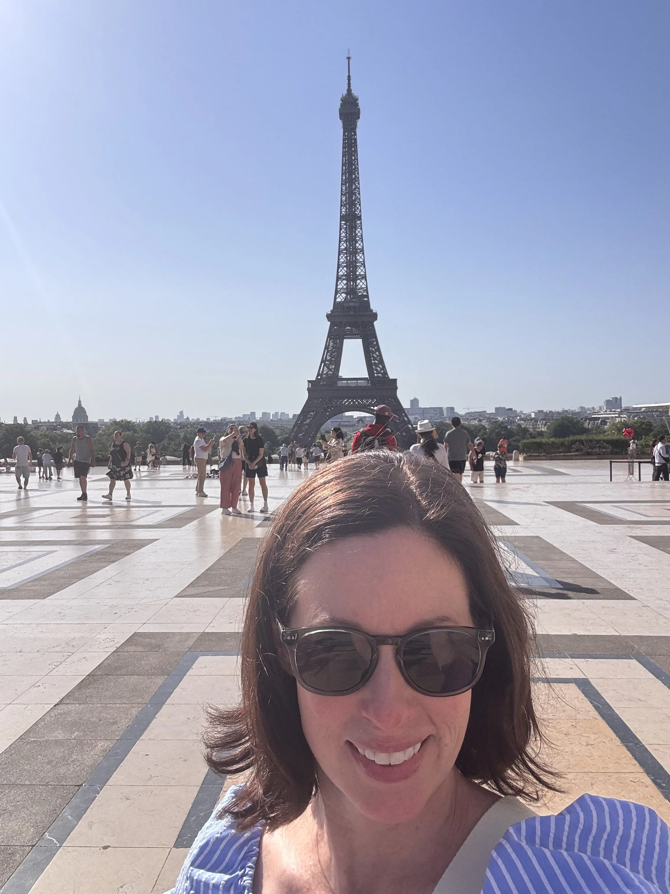 Shay Palms founder in Paris at a favorite Eiffel Tower viewing point on a sunny summer travel day.