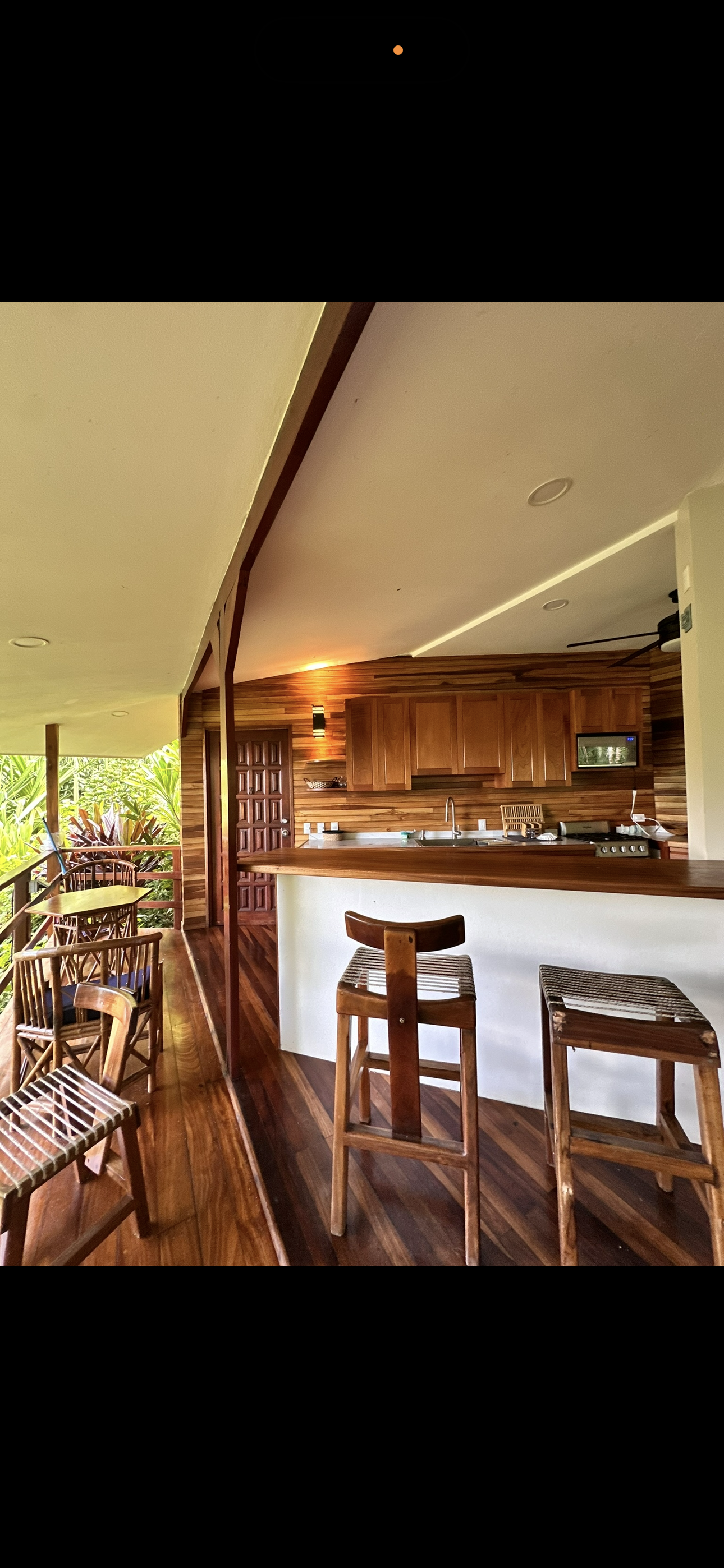 Luxury restaurant interior with bar seating, warm lighting, and upscale hospitality design.