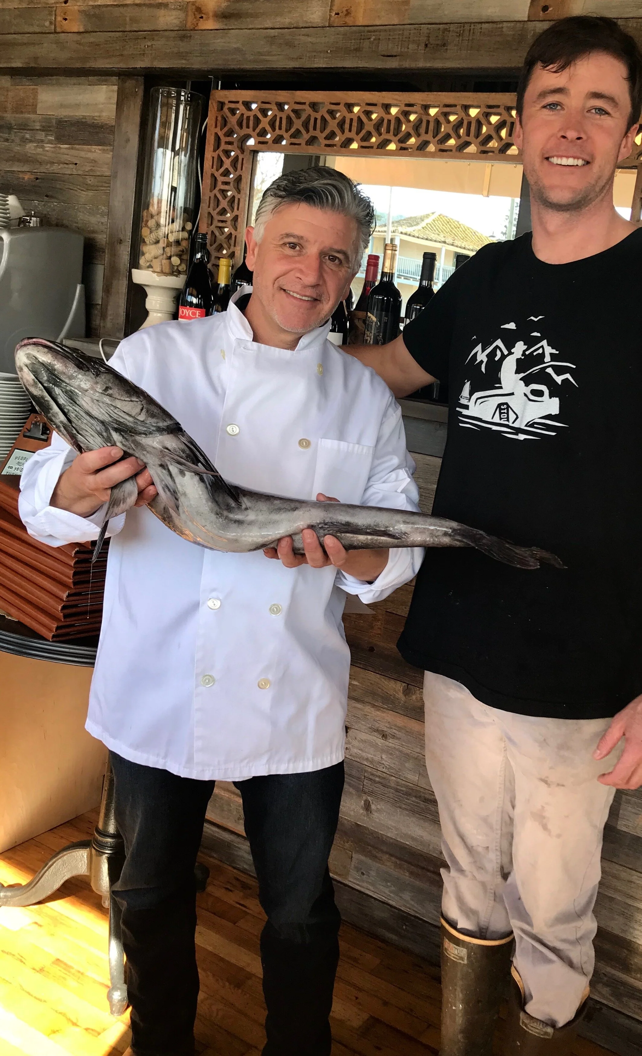 Salvatore ‘Sal’ Tedesco, owner and executive chef at Paluca Trattoria holding a sablefish delivered by Charlie Lambert from local vendor partner, Ocean2Table.