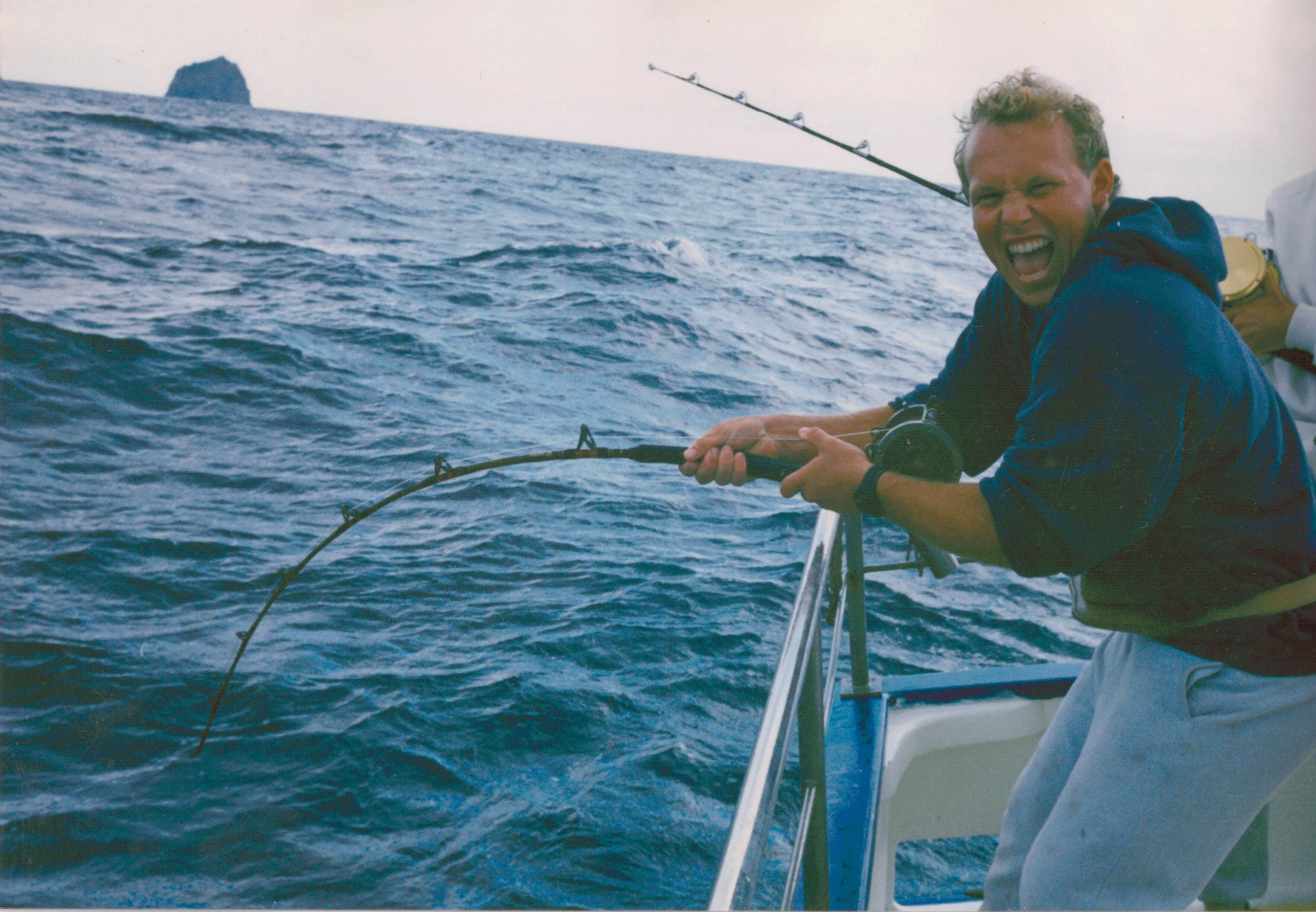 Hans Haveman of H&amp;H Fresh Fish Co. commercial fishing with a rod and reel. Photo courtesy of H&amp;H Fresh Fish Co.