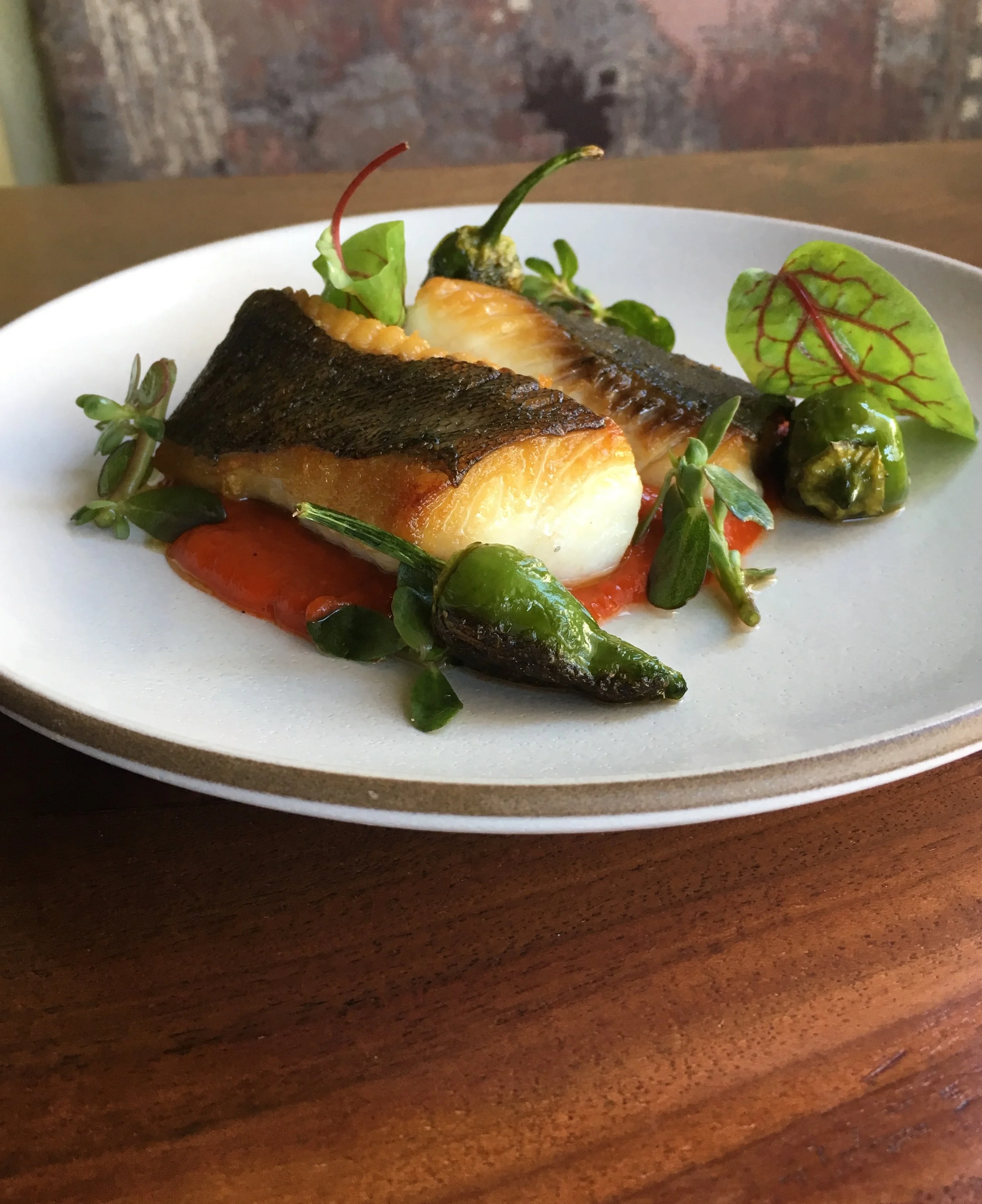 Sablefish/black cod caught by Jerry Wetle (F/V Pacific Bully) served with red pepper puree and blistered shishito peppers from Borba Farms at Wild Fish. Photo credit: Executive Chef Joshua Plesh