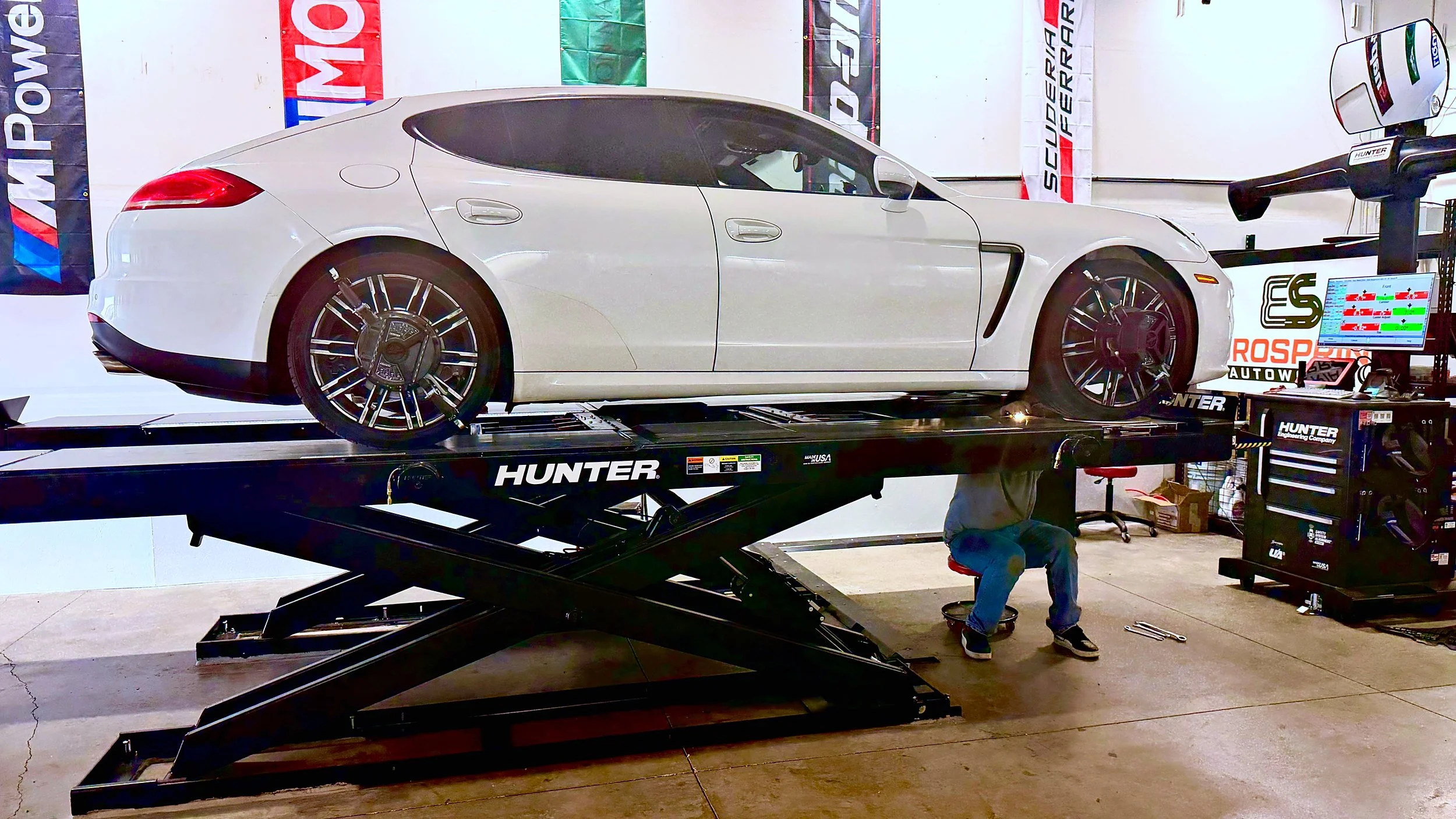 White Porsche on the Hunter Hawkeye alignment rack with a EuroSpring Autoworks tech performing the alignment.