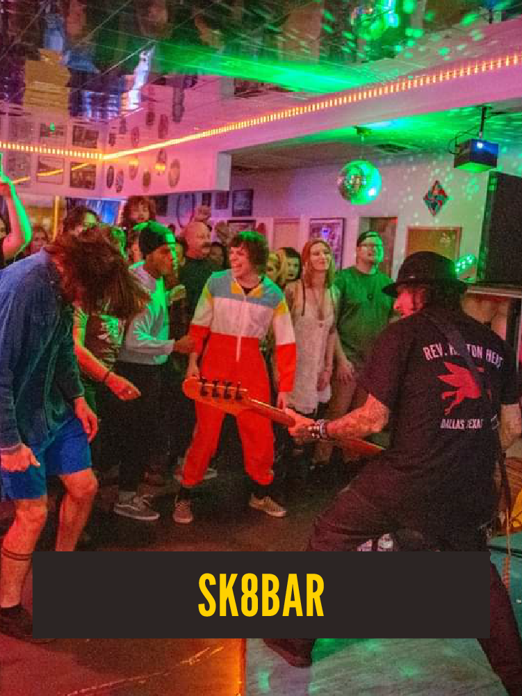 People dancing and watching a performer playing an electric guitar at a lively bar with colorful lights and disco balls.  Westport East. "SK8bar"