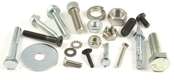 Collection of various metal bolts, screws, washers, and nuts arranged on a flat surface.
