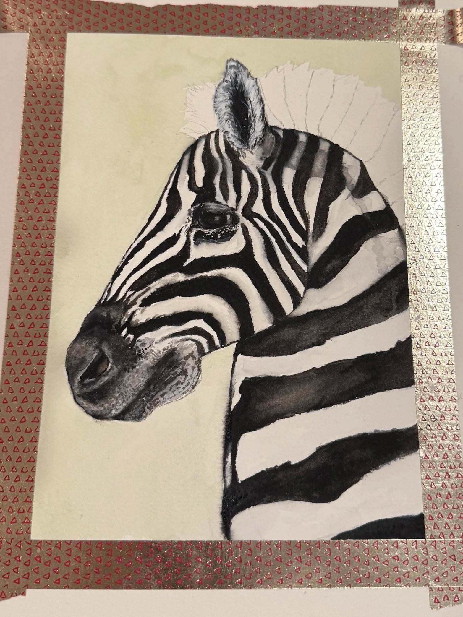 A black and white drawing of a zebra's head and torso, with the zebra laying down on a light background, surrounded by patterned tape with small red triangles.