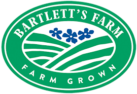 Logo of Bartlett's Farm, farm-grown, green circular emblem with stylized fields and blue flowers