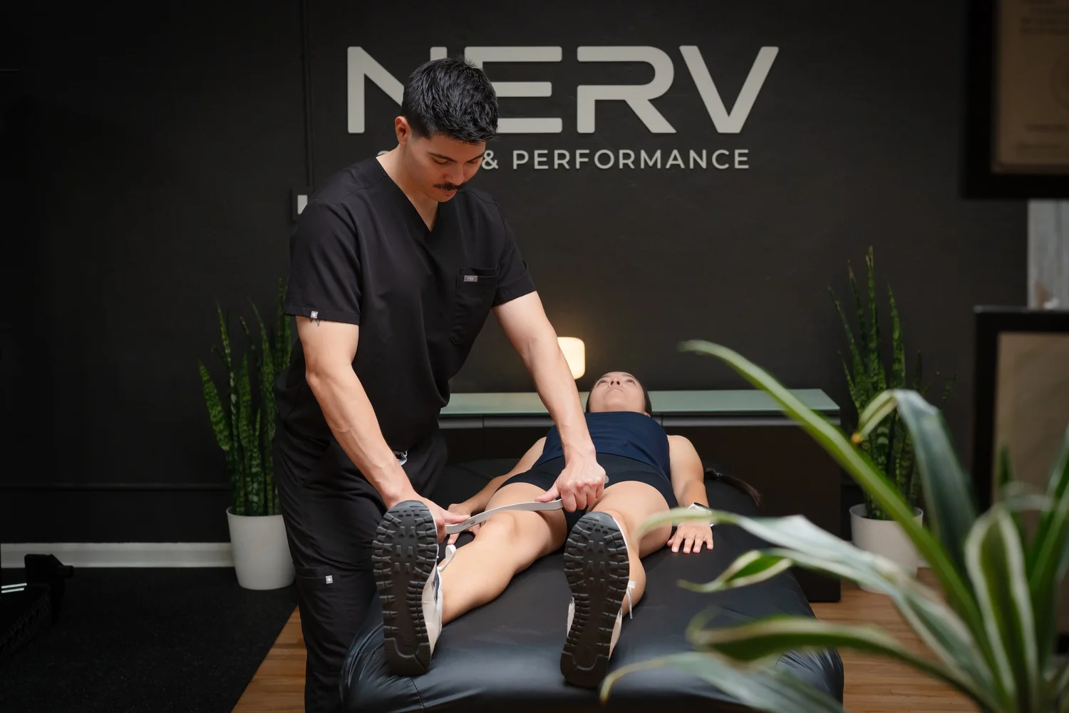 Instrument-assisted soft tissue work on the quadriceps at NERV Chiropractic in Los Angeles