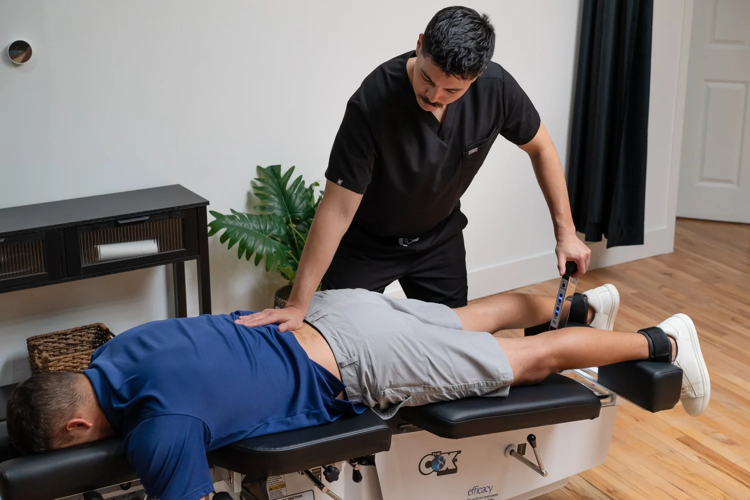 Cox flexion-distraction table in flexion during treatment at NERV Chiropractic in Los Angeles