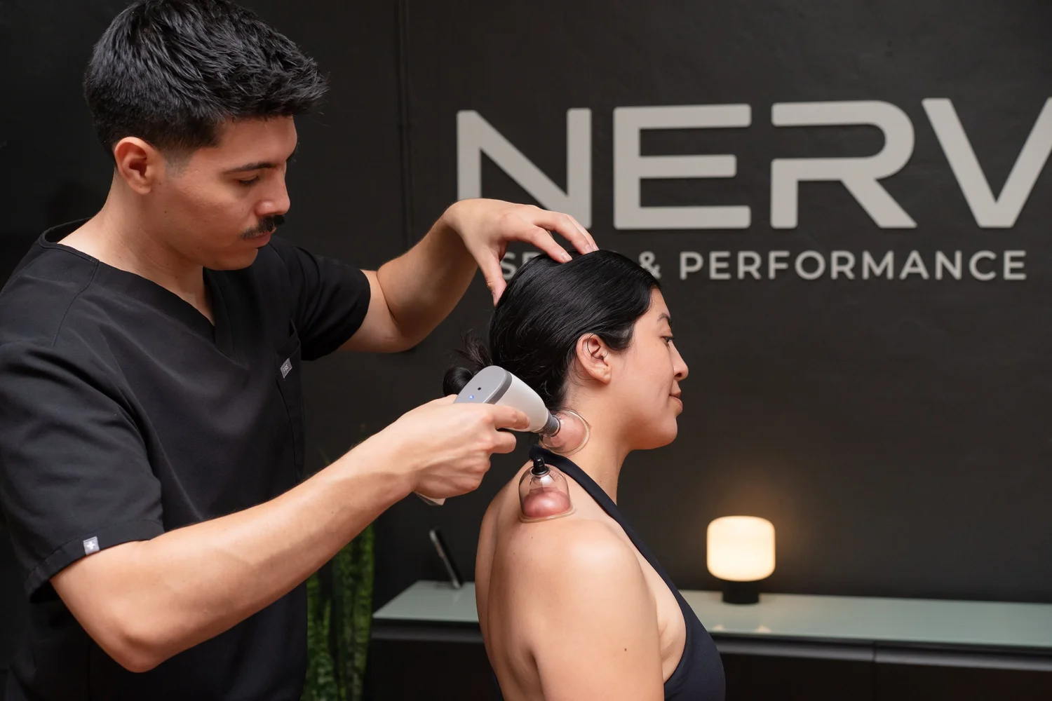 Cupping and myofascial decompression on the neck at NERV Chiropractic in Los Angeles