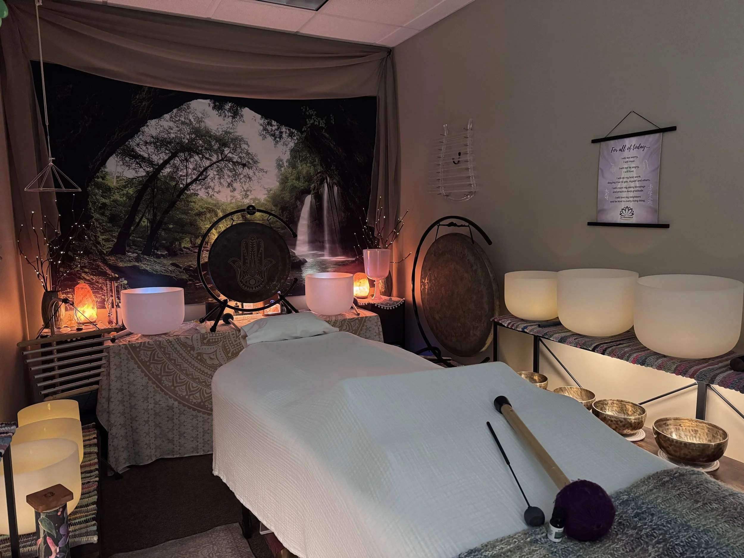 Lone Tree studio, treatment table surrounded by healing instruments, gongs, crystal & Himalayan bowls, chimes, rain stick