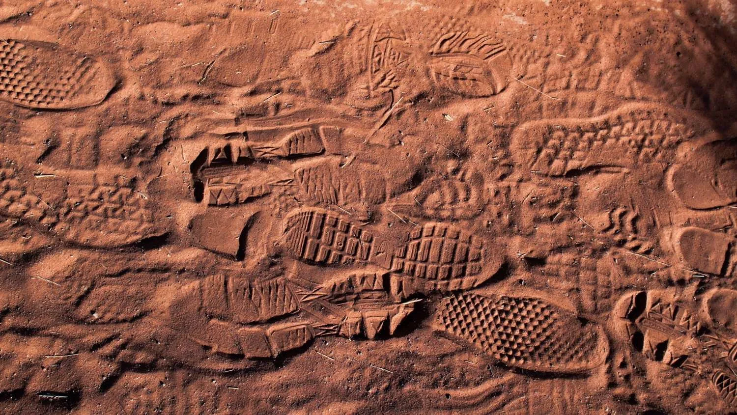 multiple shoe prints on sand