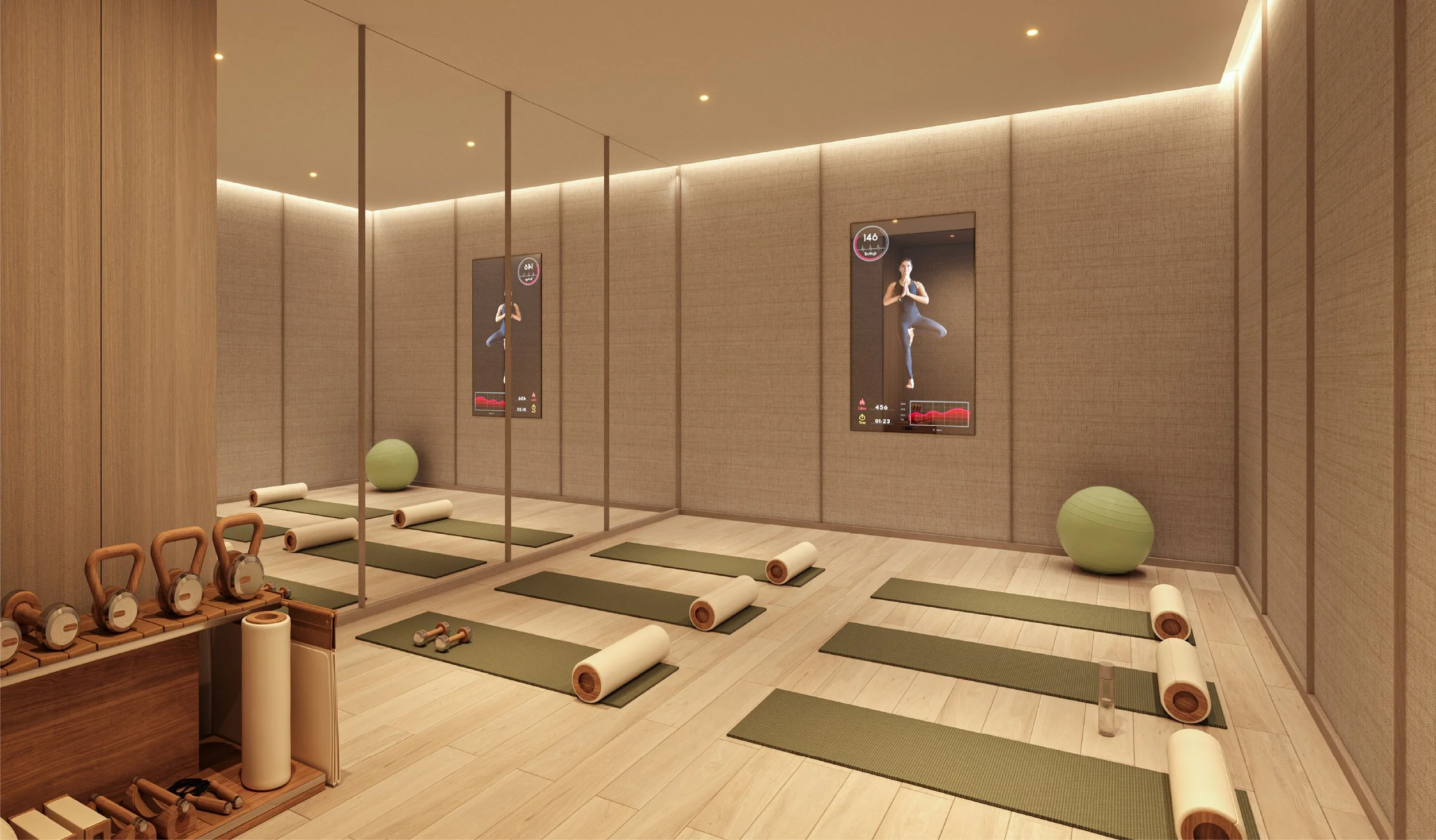 Yoga or meditation room with mats, foam rollers, kettlebells, a green exercise ball, and digital workout screens on the wall.