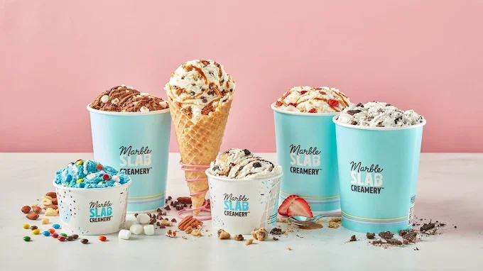 Ice cream cones and cups with various flavors and toppings on a pink background.