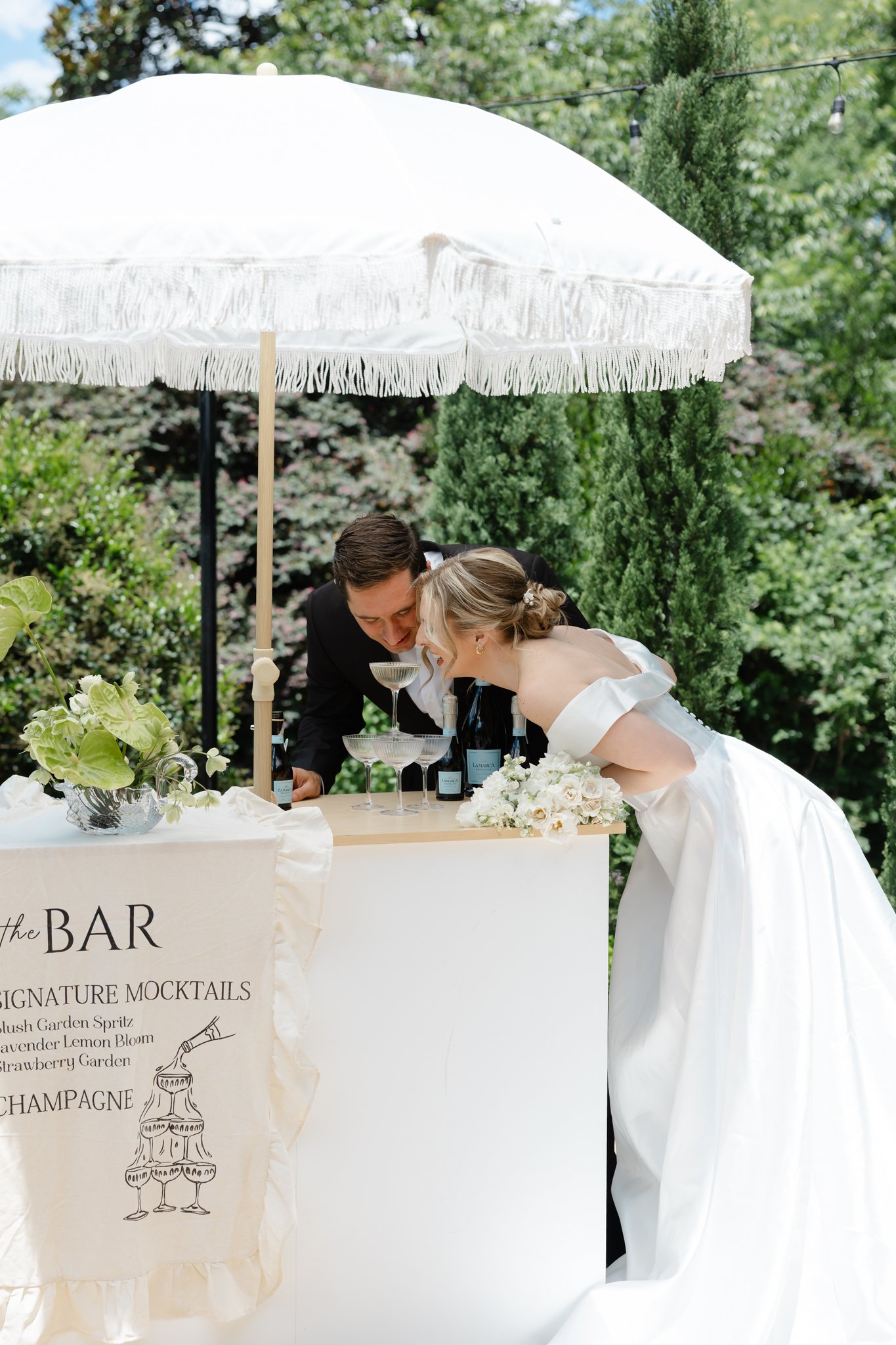 Custom wedding mocktail station featuring handcrafted drinks and luxury cart service for wedding guests.
