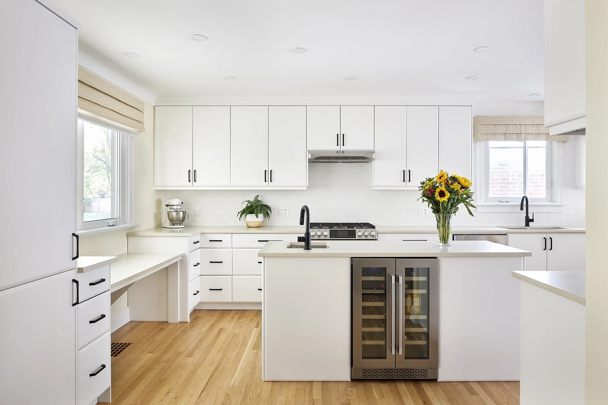 Bright white kitchen design with island and wine cooler